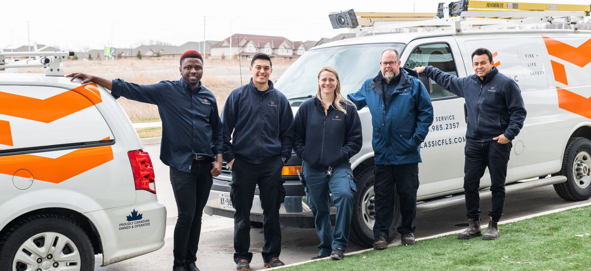 Staff standing beside Classic service vehicles